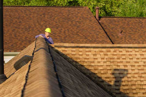 Home Inspector Examines Architectural Asphalt Shingled Roof